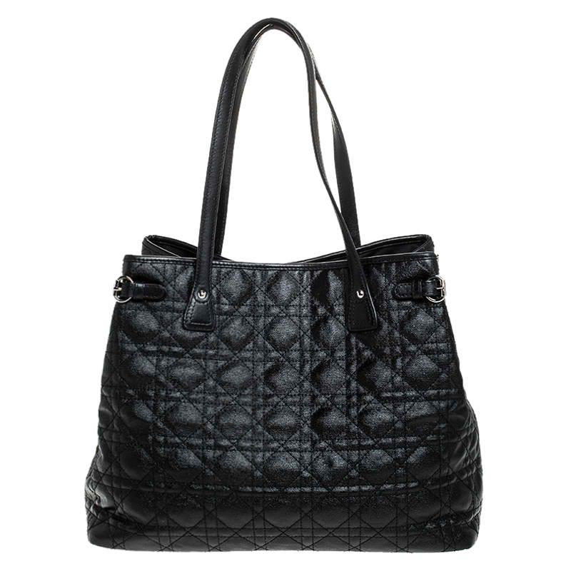 This Panarea tote from Dior is a timeless piece. The bag comes in a luxurious coated canvas cannage exterior with silver-tone hardware and Dior letter charms. It features double top handles and protective metal feet at the bottom. The nylon lined