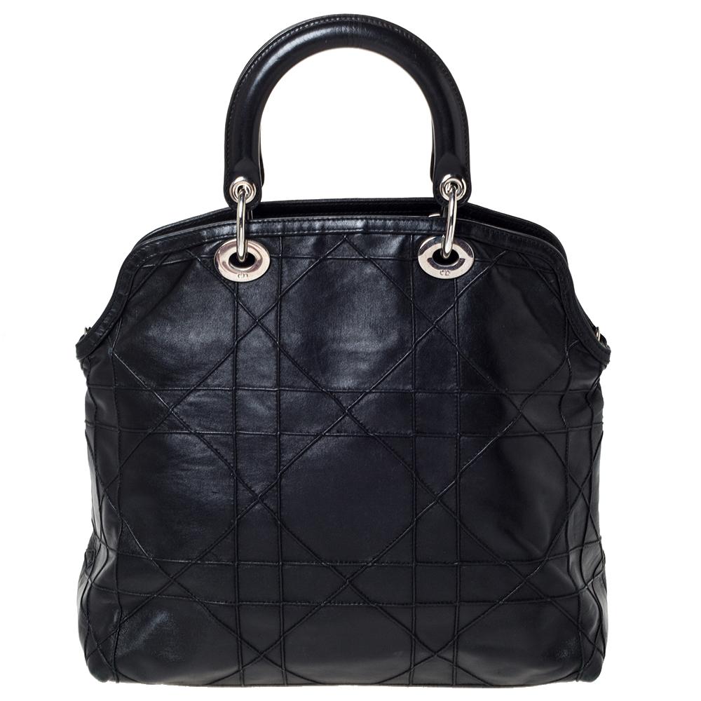 This Granville tote from Dior is a bag that every fashionista craves to possess. The bag has been crafted from leather and it carries a sleek black exterior accented with the signature cannage pattern. It is equipped with a spacious interior, two