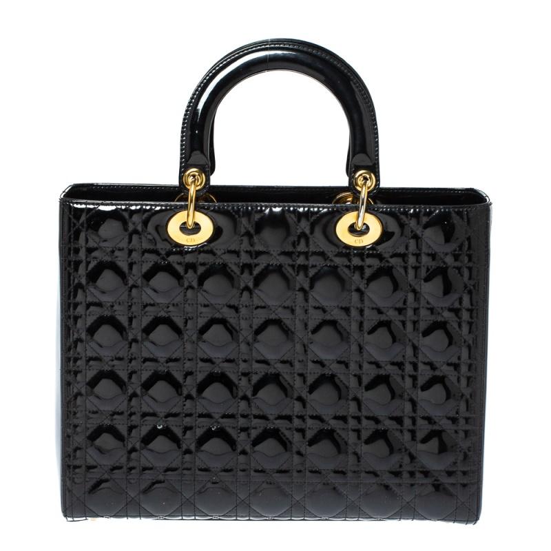 A timeless status and an example of great design mark the Lady Dior tote. It is indeed a coveted bag that every fashionista craves to possess. This black tote has been crafted from patent leather and carries the signature Cannage quilt. It is