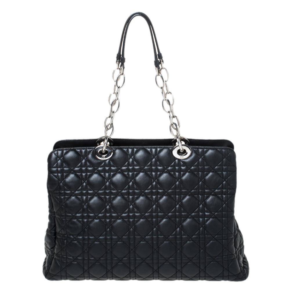 The shopping tote is a Dior creation and a coveted bag that every fashionista craves to possess. This black tote has been crafted from leather and it carries the signature Cannage quilt. It is equipped with a canvas interior and two top handles. The
