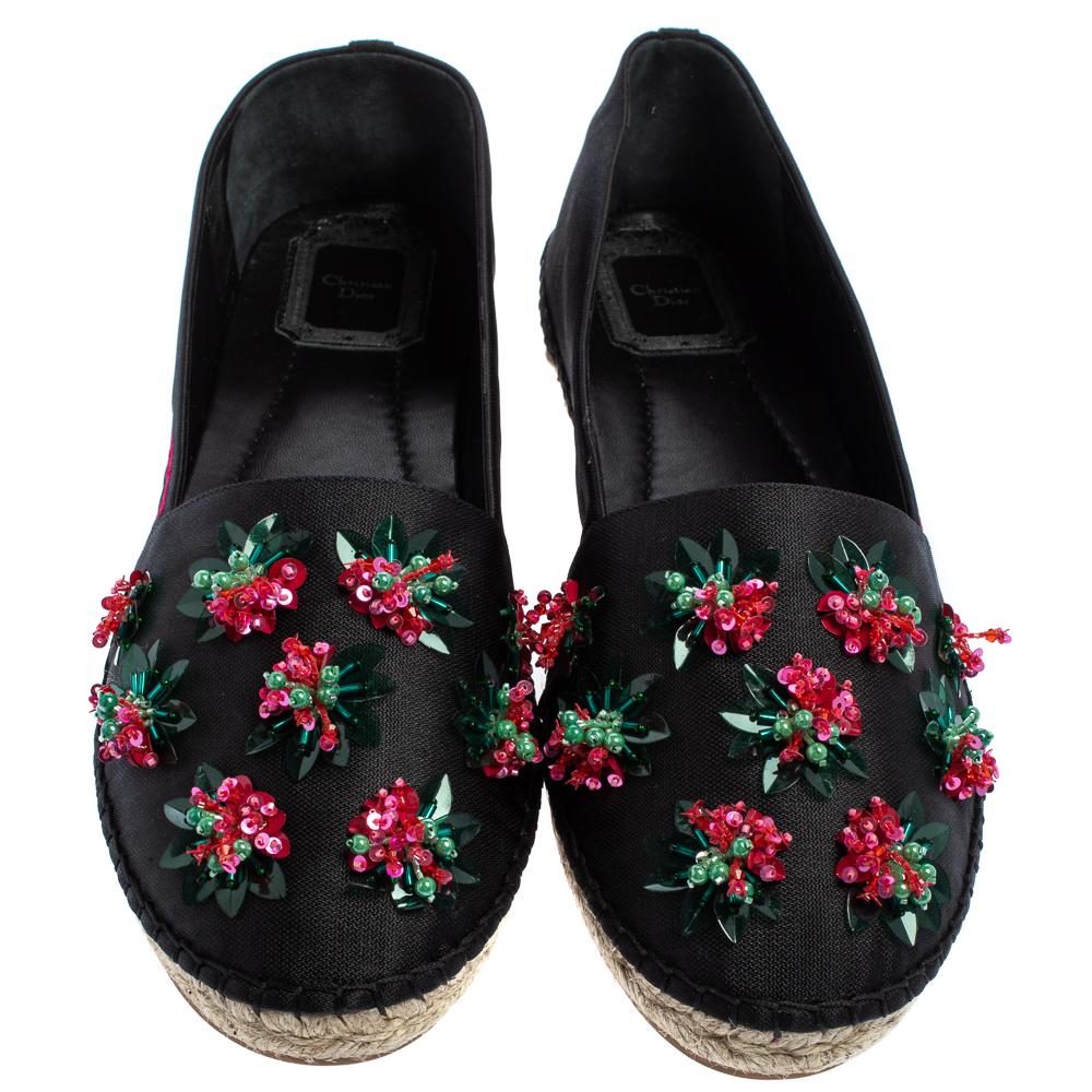These espadrilles from Dior look lovely! The black flats are crafted from canvas and feature round toes, floral embellished vamps, comfortable leather-lined insoles, and rubber soles. Pair them with a shirt and skinny jeans or a dress for a casual