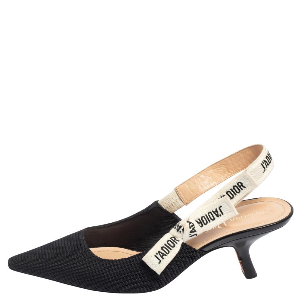 These popular J'Adior pumps exude an elegant and sophisticated aesthetic. Crafted from canvas in a black shade, the sandals have a sleek design with pointed toes. Adorned with slingbacks featuring the iconic 'J'Adior' wording and 7 cm heels, these