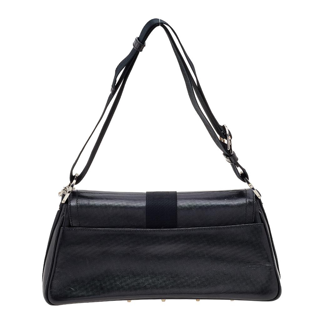 From the House of Dior, this stunning Crystal Hardcore shoulder bag will surely add oodles of panache, luxury, and elegance to your ensemble! It is made from black coated canvas on the exterior with a silver-toned logo plaque elevating its