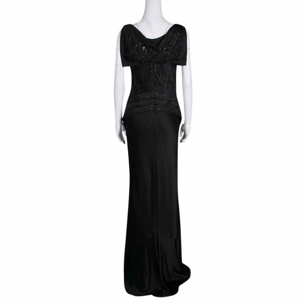 Elegance and style are brought together in this sleeveless gown from Dior. Designed to give you a statement look, this black outfit has an embellished bodice with subtle drape details and a modishly designed rear. It exudes a classy finish with its