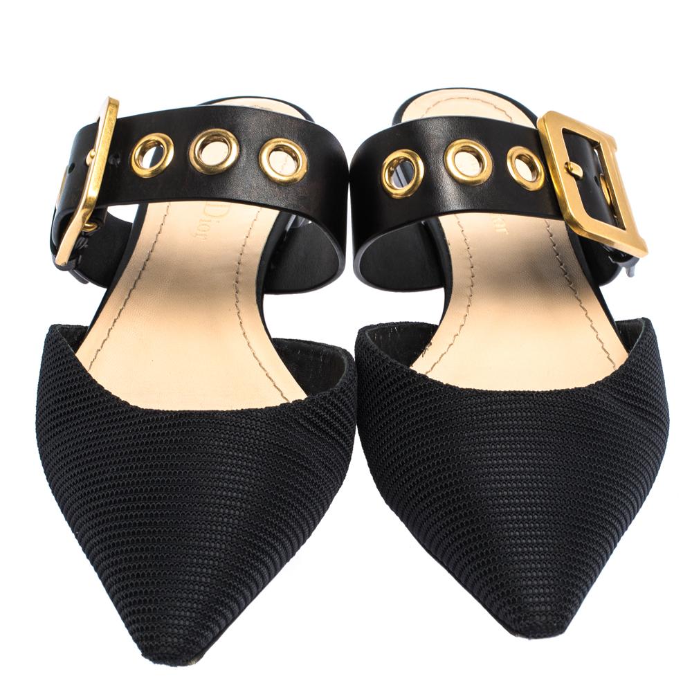 A gorgeous pair of mules from the house of Dior to highlight your fabulous styling choices. Match your outfit with these black flats that come designed with fabric vamps and buckled leather straps at the ankles. This pair features pointed toes and