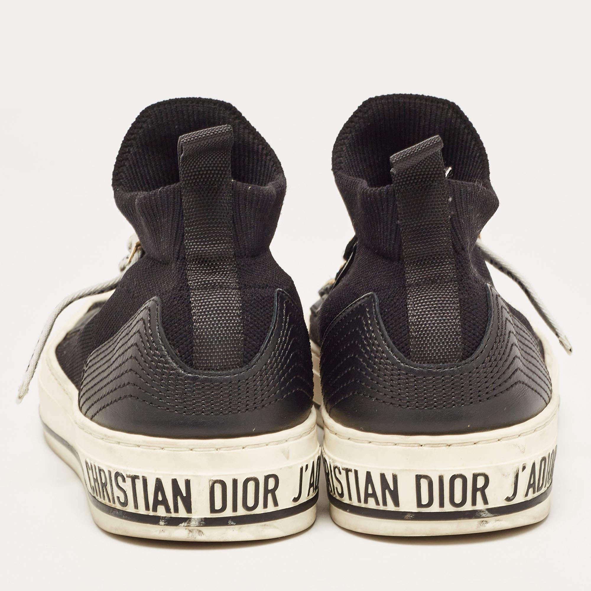 Add a statement appeal to your outfit with these Dior sneakers. Made from fabric and leather, they feature lace-up vamps, a brand signature on the uppers, and comfortable insoles. The leather sole of this high-top pair aims to provide you with