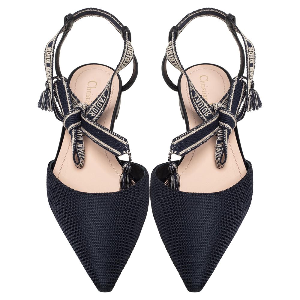 Endless compliments will come your way every time you wear these Dior flats. The black flats are crafted from fabric and styled with pointed toes and 'Christian Dior J'Adior' embroidered ankle wraps. They are complete with comfortable leather