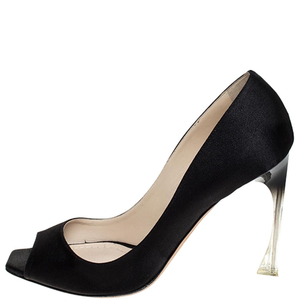Dior takes on minimalism in a fashionable way with these pumps. Made in Italy from black fabric, these peep-toe pumps are brilliantly designed with lucite heels. This pair is comfortably padded in leather to ensure quality in and out.

Includes: The
