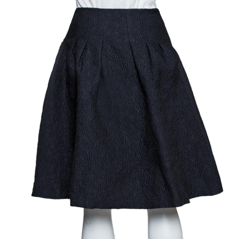 You'll not only love having this skirt in your closet but you'll also love flaunting it whenever you step out of your house. The skirt is a Dior creation and it comes flowing with style. Made from a cotton blend, the skirt carries a black shade and