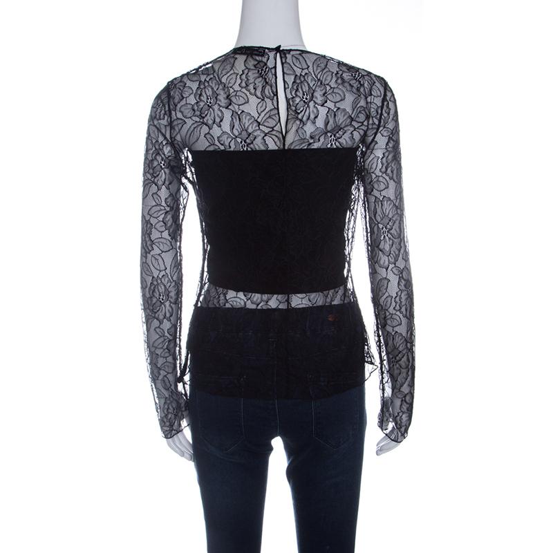 There is something incredibly chic, feminine and flattering about lace just like this Dior top. It features a floral lace body with full sleeves and shows just the right amount of skin. It features a rounded neckline and secured with a hook closure