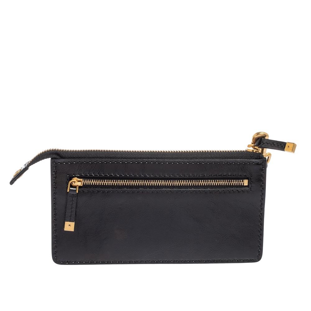 This Dior wristlet pouch is made of glazed leather in black. It has star motifs and 'J'ADIOR' on the front in gold-tone metal and the top zipper secures the lined interior. A wristlet strap and back zip pocket complete the pouch.

Includes: Brand