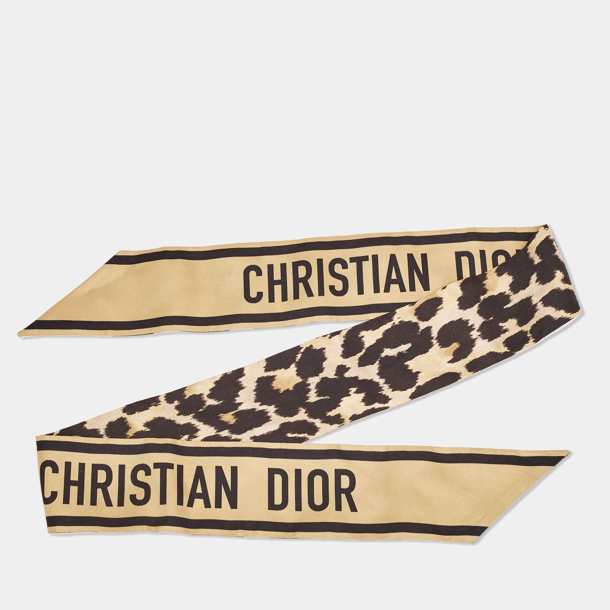 The Dior mitzah scarf embodies timeless elegance with its luxurious silk fabric adorned in a striking black and gold leopard print motif. Its sleek design adds a touch of sophistication to any ensemble, making it a versatile accessory for both day