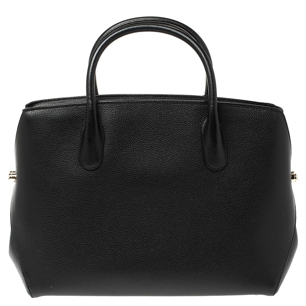 This tote from Dior is designed to assist you with style and functionality! It comes crafted from black grained leather and features dual top handles. It carries the 'DIOR' letter charms within a clochette and opens to a capacious leather interior