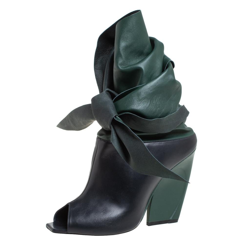 Well, isn't this Dior pair simply stunning! They've been designed so beautifully with leather that they make one's heart flutter. The ankle boots come in a mix of green and black leather, with peep toes, finely sculpted 12 cm heels and a wrap style