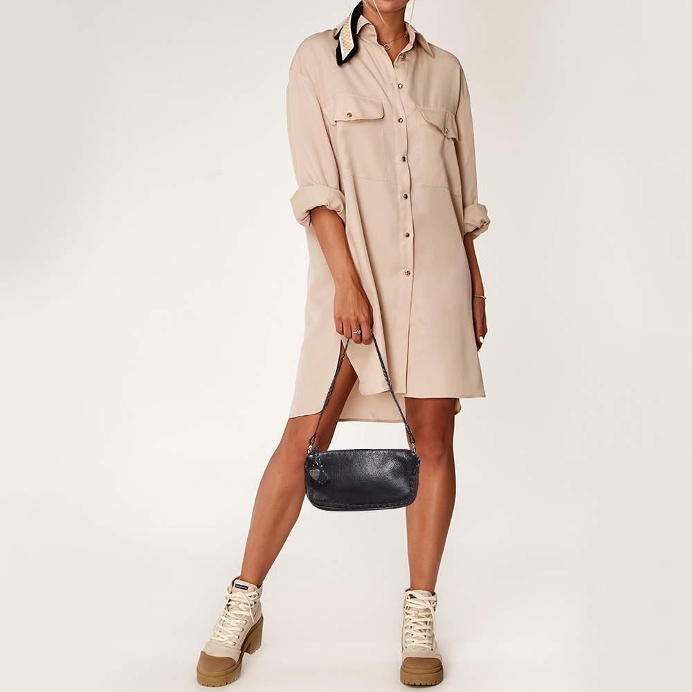 Perfect for conveniently housing your essentials in one place this Dior bag is a worthy investment. It has stud details and offers a look of luxury.