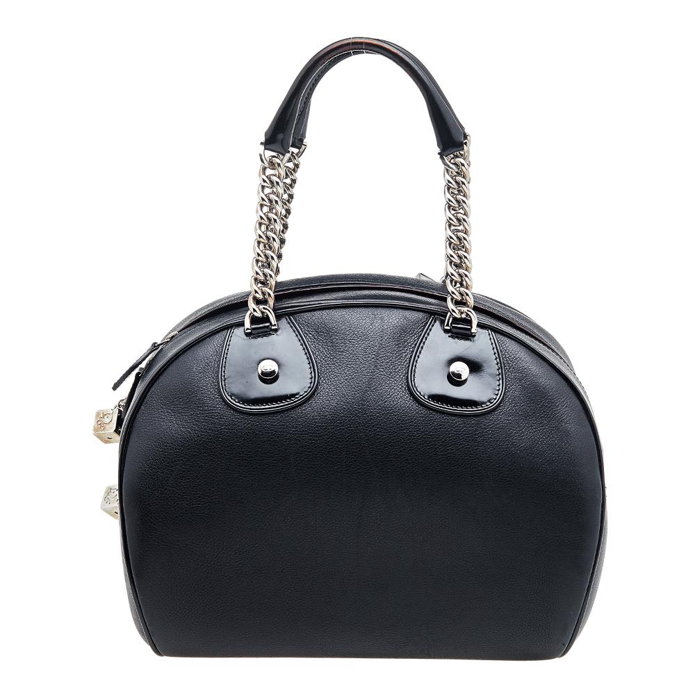Flawless craftsmanship and timeless design aesthetics combine to make this Dior Bowler bag perfect from workday to the weekend. It is sewn using black leather and designed with dangling DIOR metal dices and two handles. The spacious fabric interior