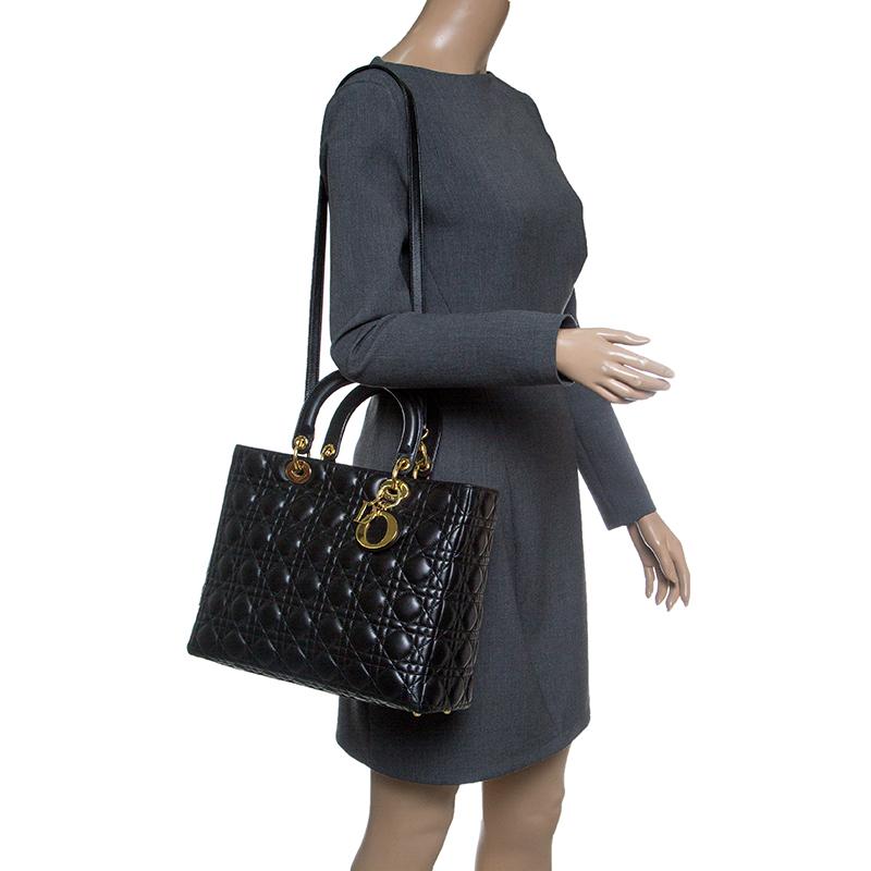 The Lady Dior tote is a Dior creation that was designed in 1994 and has gained lovers worldwide. Crafted from black leather this tote carries a cannage pattern exterior. It is equipped with dual rolled top handles, a shoulder strap, classic Dior