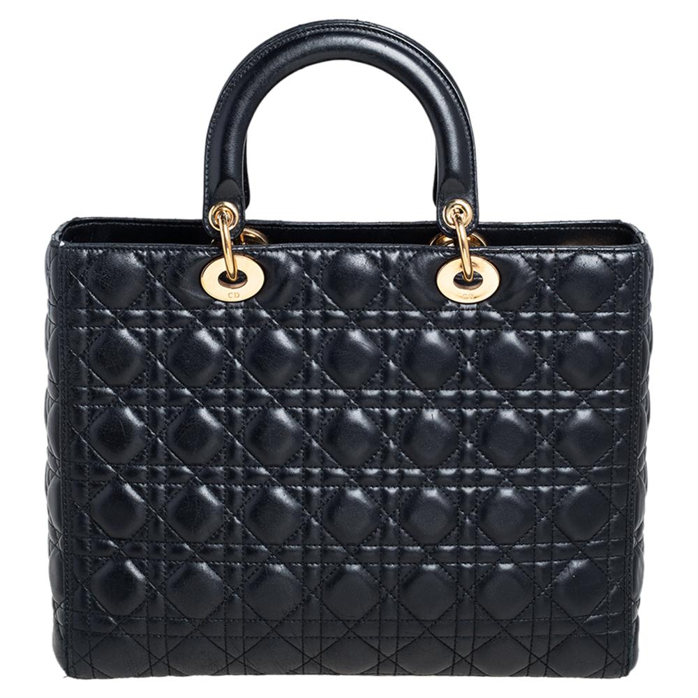A timeless status and great design mark the Lady Dior tote. It is an iconic bag that people continue to invest in to this day. We have here this beauty crafted from black leather. The bag has a spacious nylon-lined interior housing a zipper pocket