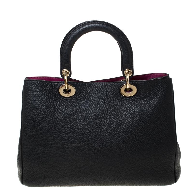 The Diorissimo shopper tote from Dior is a piece that has never gone out of style. The leather bag comes in a black shade with gold-tone hardware and Dior letter charms. It features double top handles, a small pouch and protective feet at the