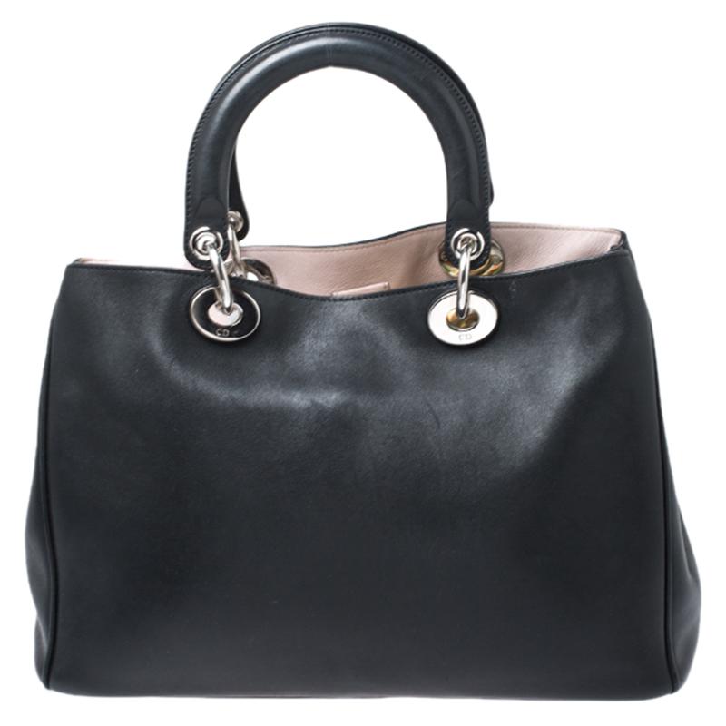 The Diorissimo shopper tote from Dior is a piece that has never gone out of style. The leather bag comes in a black shade with silver-tone hardware and Dior letter charms. It features double top handles, a shoulder strap and protective feet at the