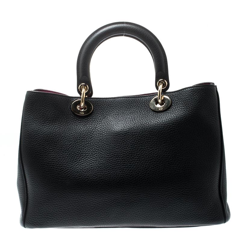 The Diorissimo bag from Dior is a piece that has never gone out of style. The leather bag comes in a classy black shade with gold-tone hardware and Dior letter charms. It features double top handles, a shoulder strap and protective feet at the