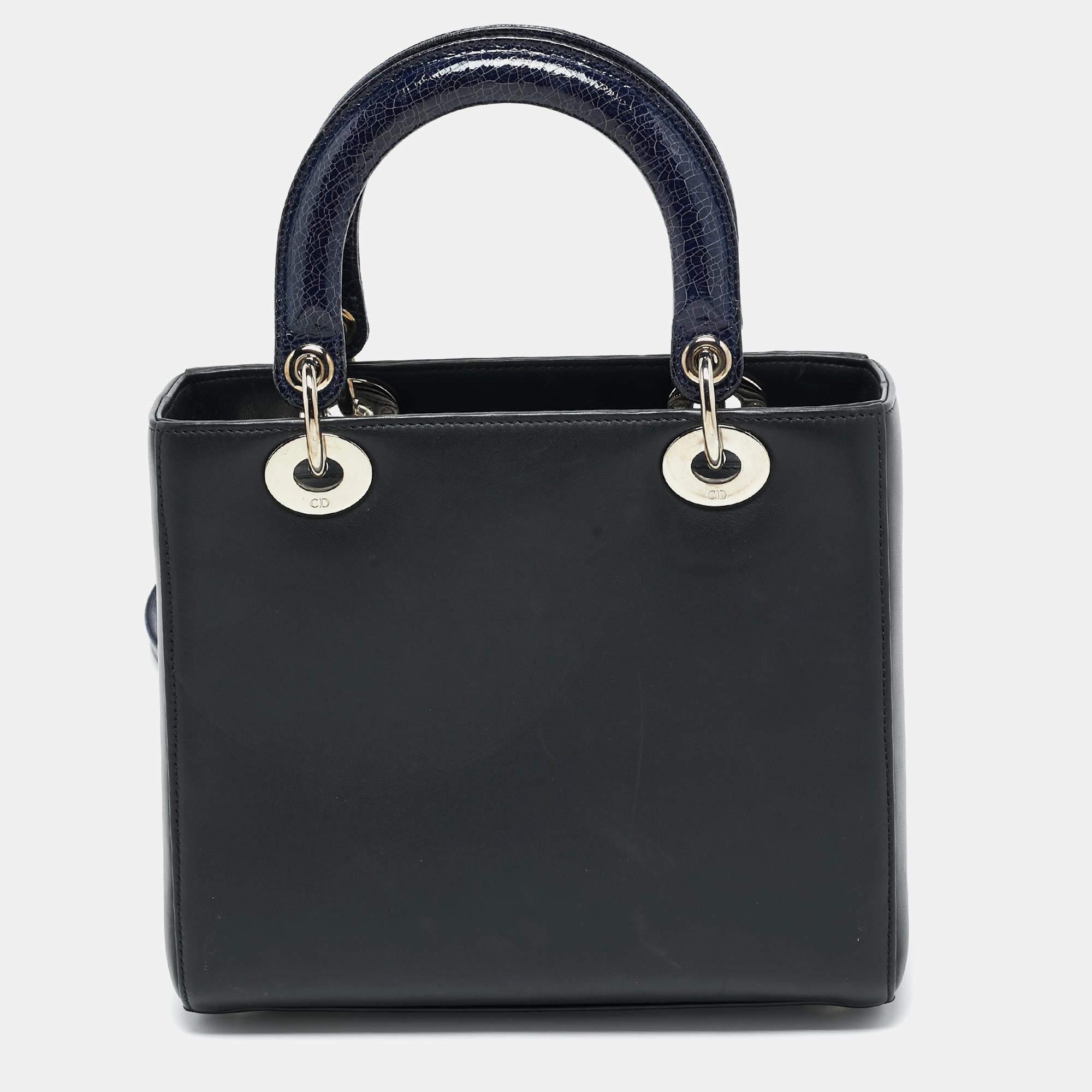 A timeless status and great design mark the Lady Dior tote. It is an iconic bag that people continue to invest in to this day. We have here this beauty crafted from leather and added with embellishments. The bag has a spacious leather-lined interior