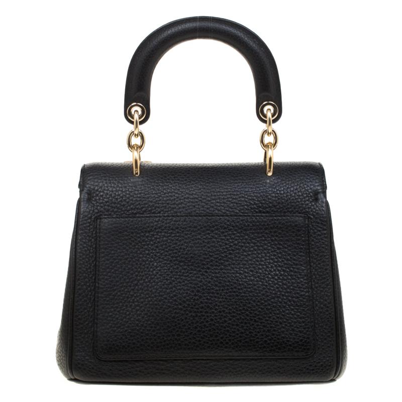Flap bags as gorgeous as this one from Dior will never go out of style. This beauty has been meticulously crafted from leather and equipped with a single rolled top handle, a removable shoulder strap, protective metal feet at the bottom and the Dior