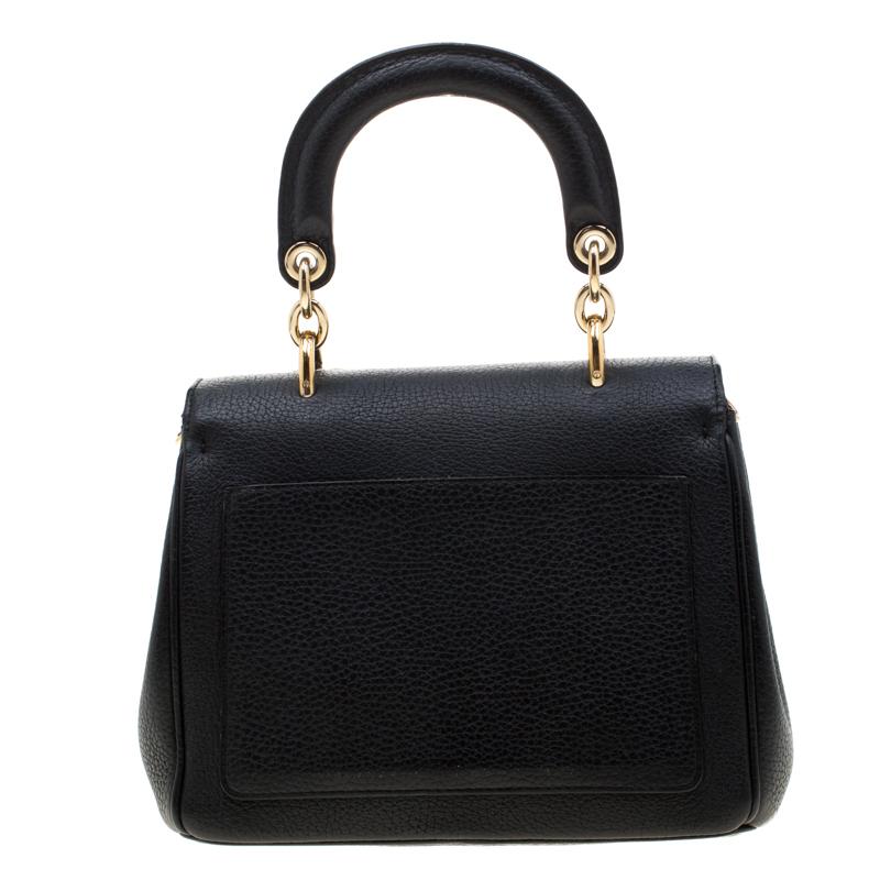 This Be Dior bag from the house of Dior is sure to add sparks of luxury to your wardrobe! It is crafted from leather and features a chic silhouette. It flaunts a single rolled top handle with attached 'DIOR' letter charms and comes equipped with