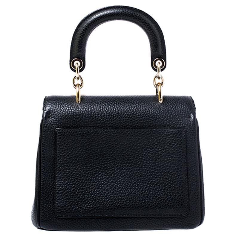 Flap bags as gorgeous as this one from Dior will never go out of style. This beauty has been meticulously crafted from leather and equipped with a single rolled top handle, protective metal feet at the bottom and the Dior letter charms. The flap
