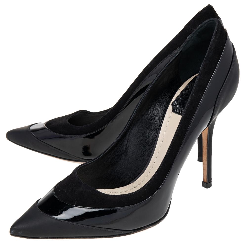 A feminine flair, sleek cuts, and a timeless appeal characterize these stunning Dior pumps. Crafted from quality materials in a black shade, the silhouette is adorned with pointed toes and raised on stiletto heels.

