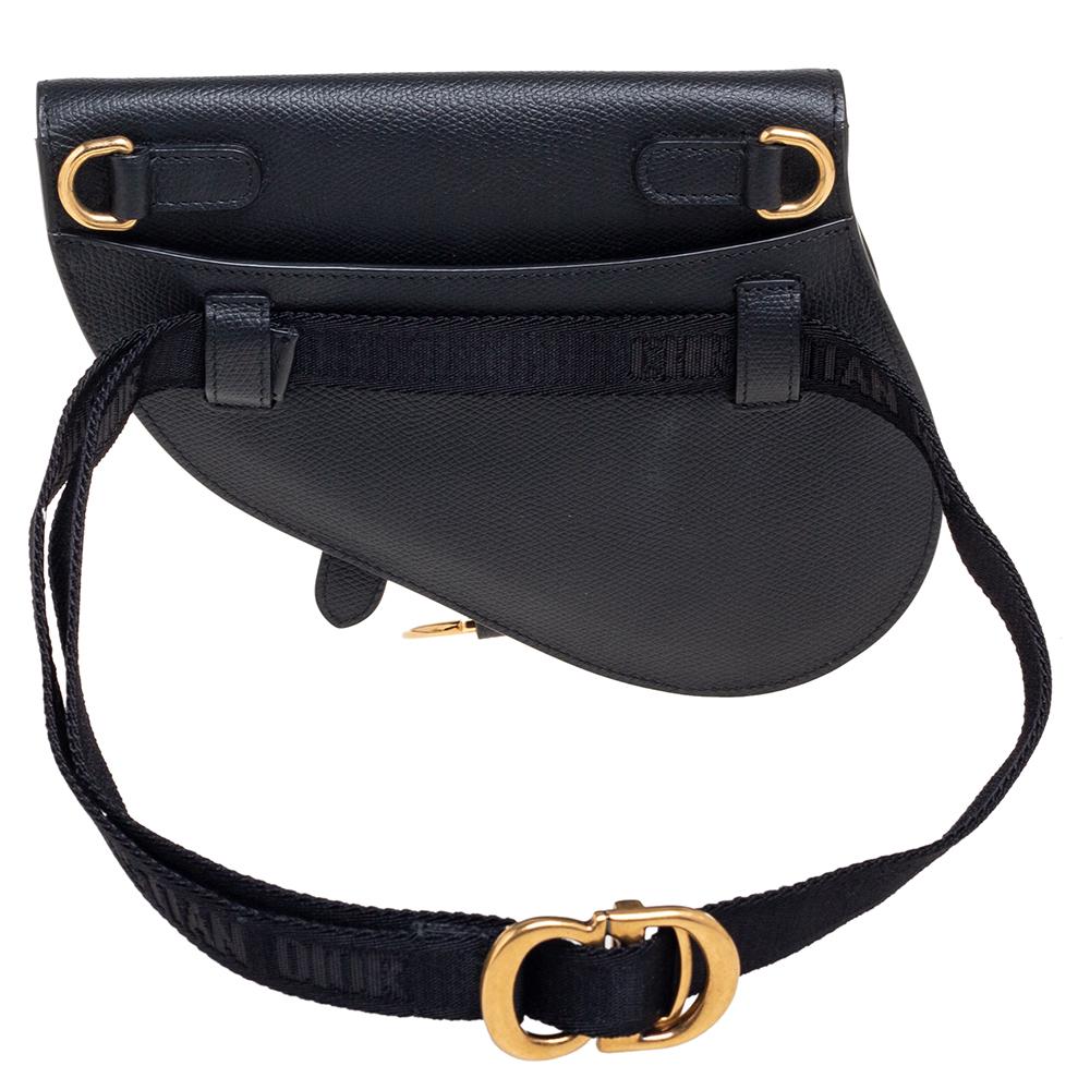 Owing to its uniquely-crafted silhouette and timeless elegance, the Saddle bag remains one of the most significant designs of the brand. This Saddle belt bag is carved using black leather, with a gold-toned D charm hanging down the front. Its belt