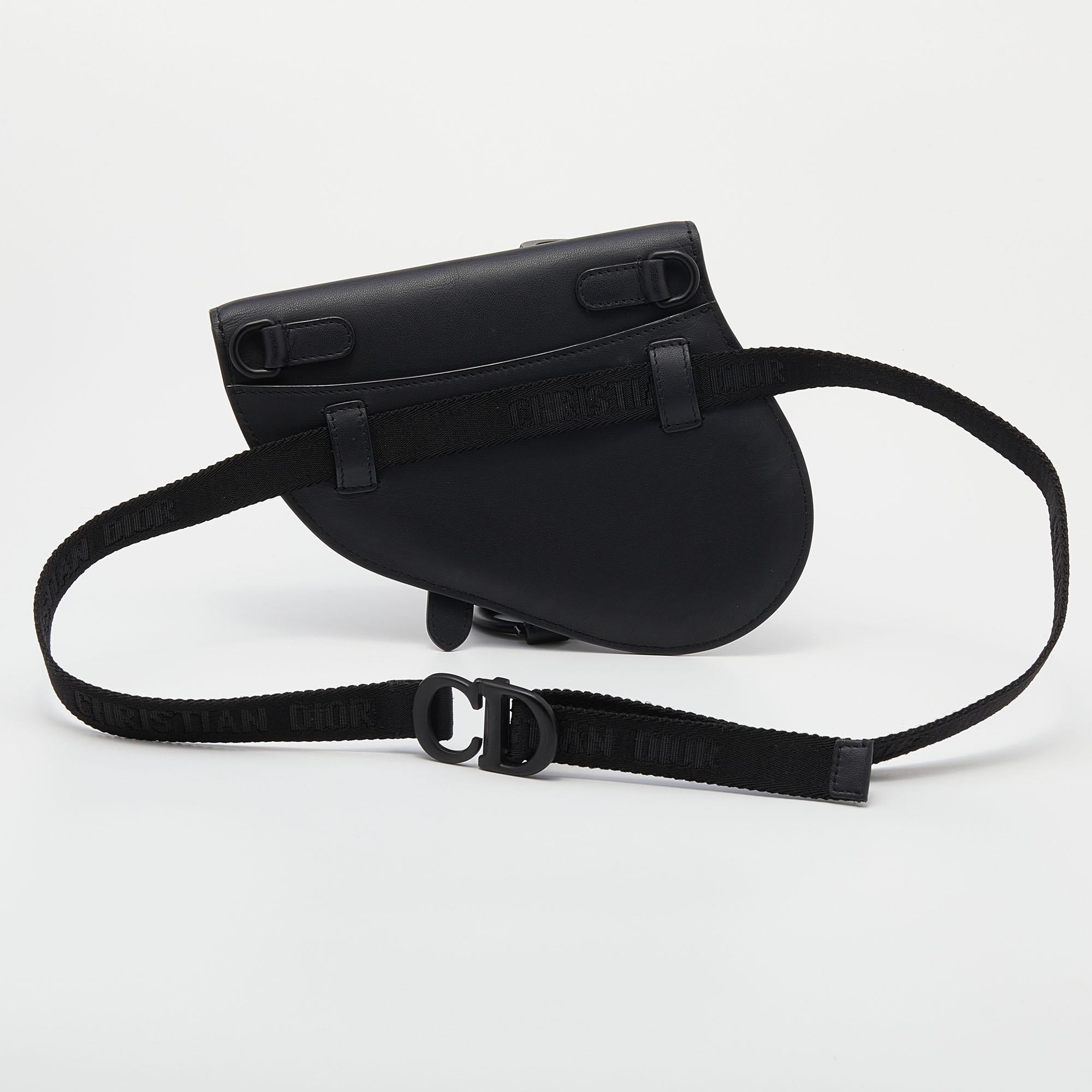 Owing to its uniquely-crafted silhouette and timeless elegance, the Saddle bag remains one of the most significant designs of the brand. This Saddle belt bag is carved using black leather, with a black-toned D charm hanging down the front. Its belt