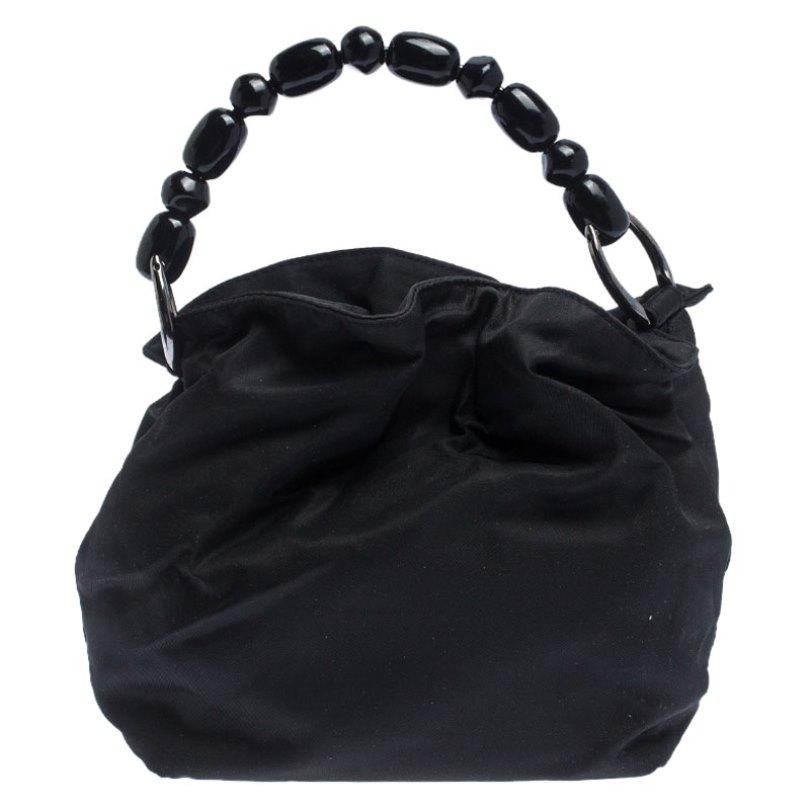 Every modern-day wardrobe needs a Dior handbag like this. A practical and elegant everyday bag in a lovely black colour, this one is made from nylon. It is held by a single handle, features silver-tone hardware and comes with a well-sized