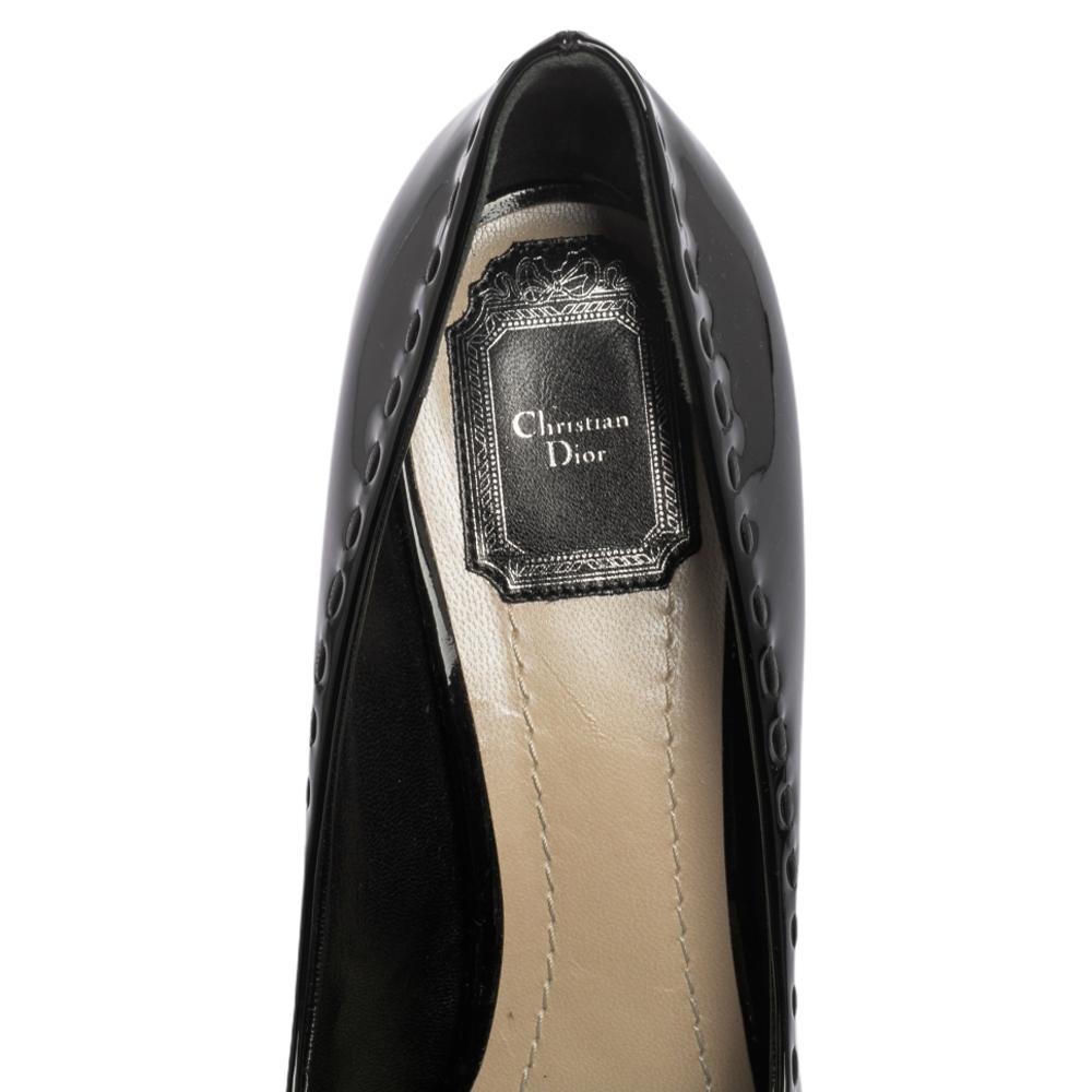 Luxuriously crafted peep-toe pumps by Dior to offer you an elegant look. They are covered in black patent leather, enhanced with bows, and lifted on platforms and 12 cm heels.

Includes: Original Dustbag