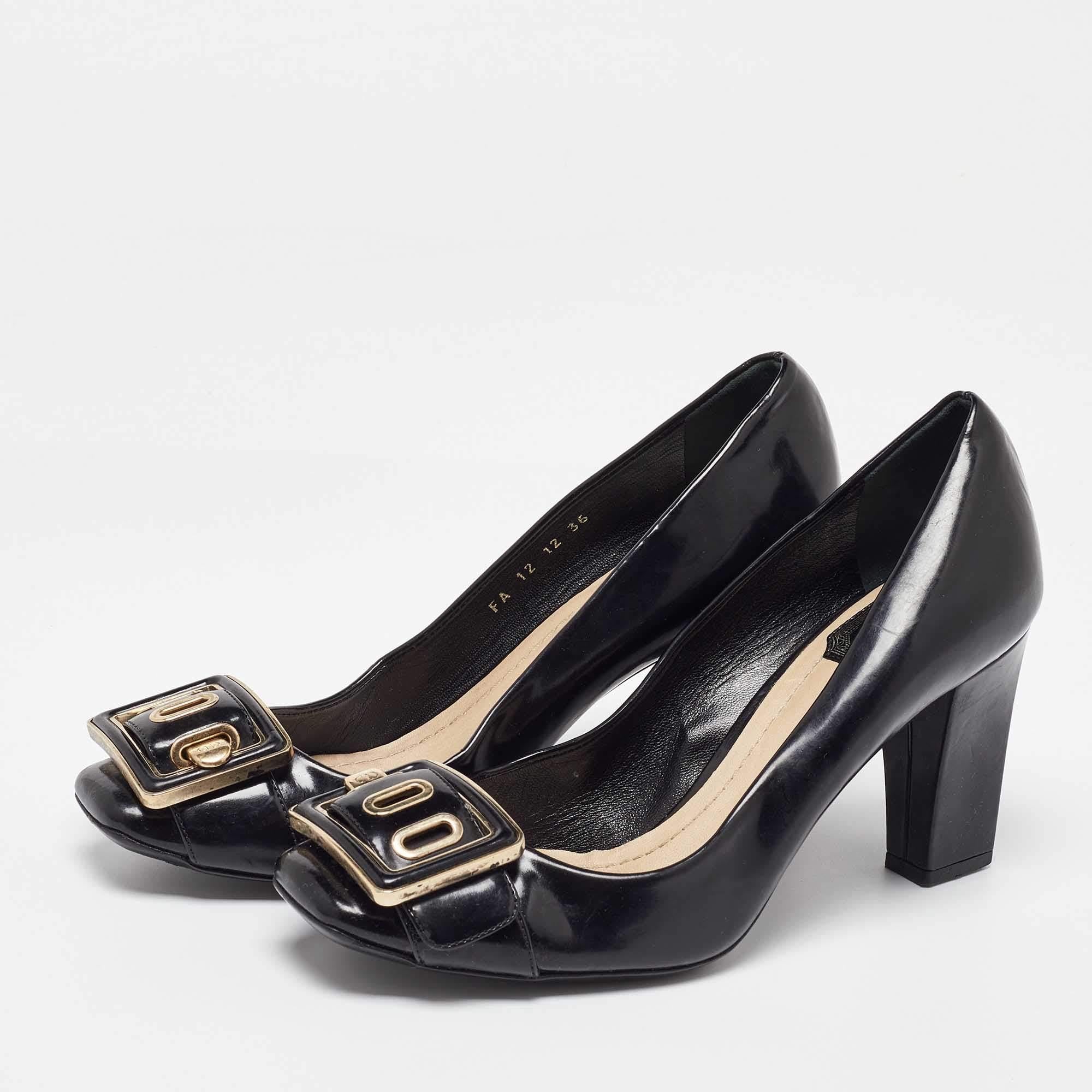 Simple elegant and versatile Diors pumps exemplify the labels brilliant craftsmanship in shoemaking. Made from patent leather in a black shade they feature oversized buckles on the uppers accented by the brands name. The pumps are set on 8 cm block