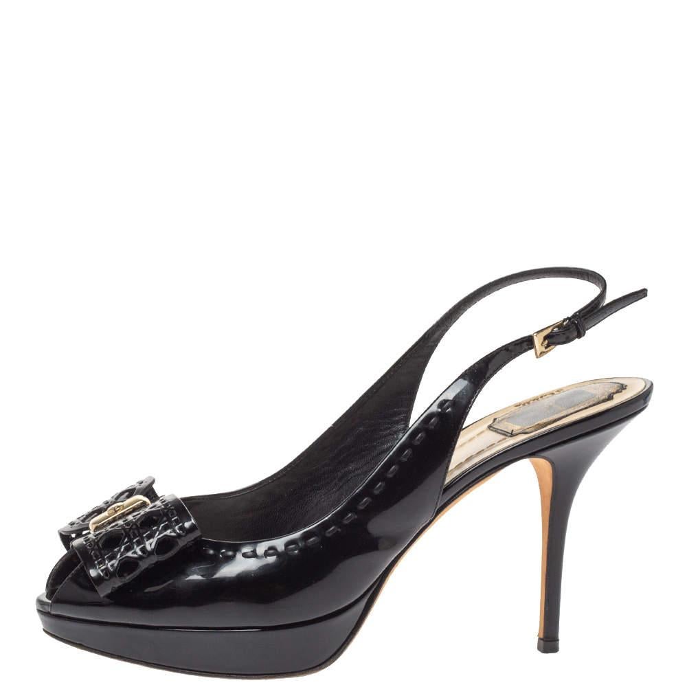 Make a bold style statement as you flaunt these Dior pumps and they come crafted from black leather. They have been styled with cannage patterned butterfly-shaped bow motifs on the vamps and buckled slingbacks and endowed with comfortable