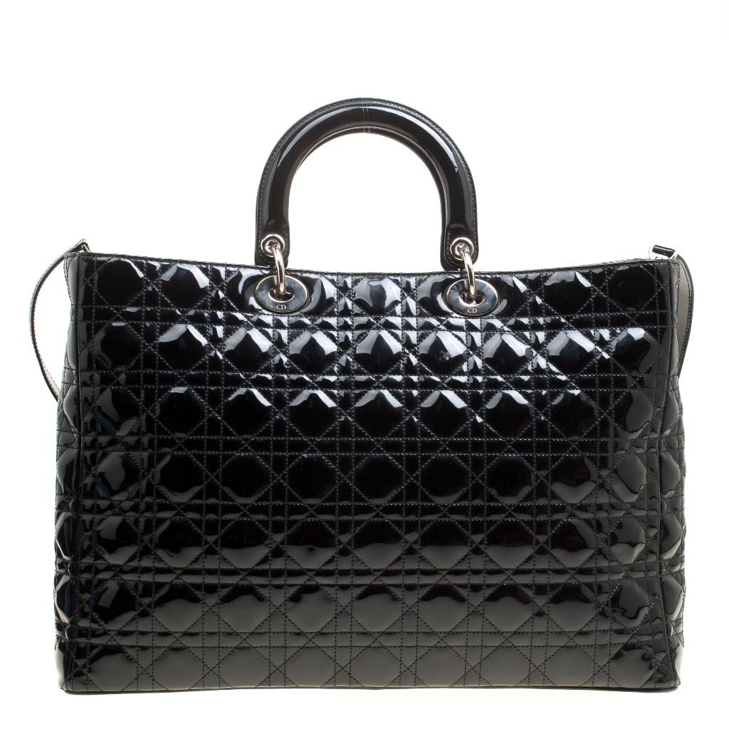 The Lady Dior bag is a Dior creation that was designed in 1994 and has gained lovers worldwide. Crafted from black leather this bag carries a cannage pattern exterior. It is equipped with dual rolled top handles, a shoulder strap, classic Dior