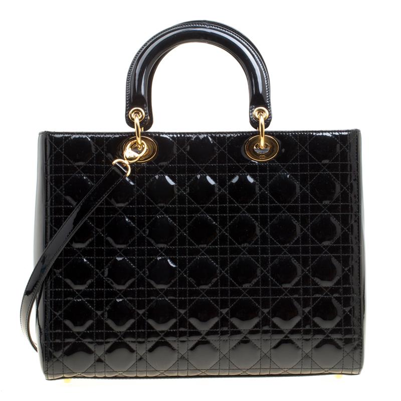 The Lady Dior tote from Dior is remarkable, highly coveted, and since its birth in 1994, it has swayed us with its shape, design, and beauty. This black version is a joy to witness! It comes meticulously crafted from patent leather and designed in