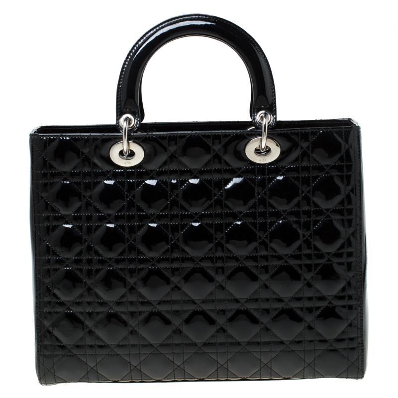 The Lady Dior tote is a Dior creation that has gained recognition worldwide and is today a coveted bag that every fashionista craves to possess. This black version has been crafted from patent leather and it carries the signature Cannage quilt. It