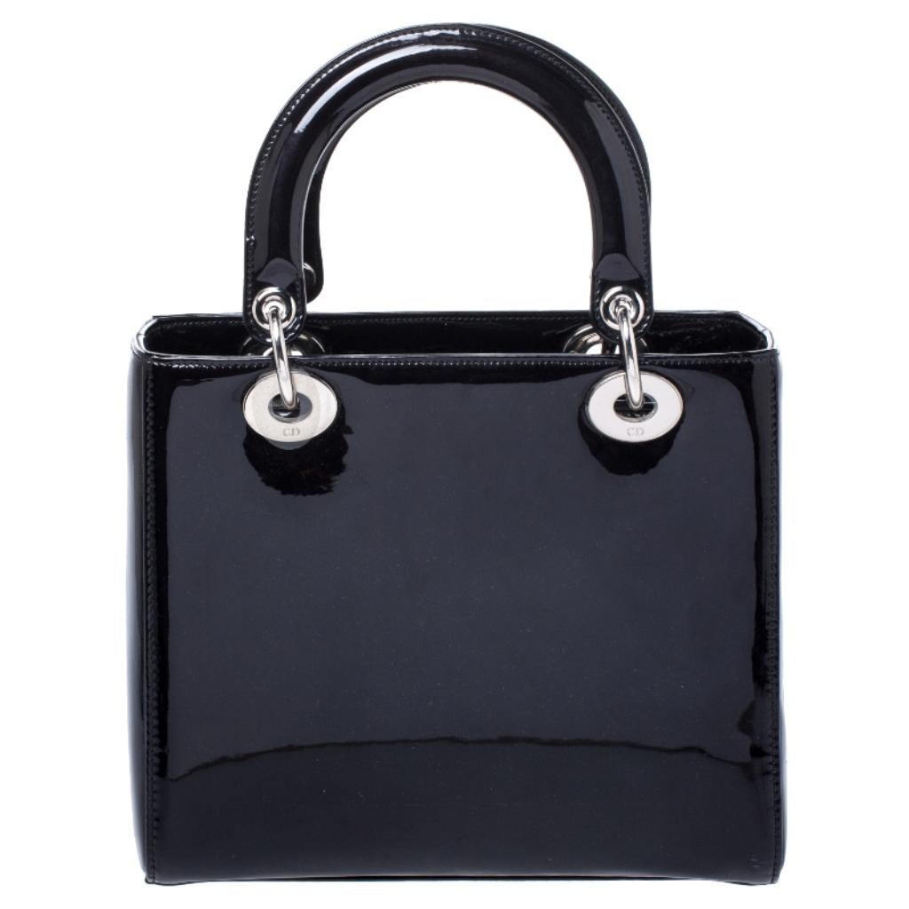 The Lady Dior tote is a Dior creation that has gained recognition worldwide and is today a coveted bag that every fashionista craves to possess. This black tote has been crafted from patent leather. It is equipped with a leather interior and two top