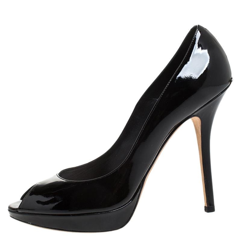 These elegant Dior pumps are your favourite go-to option for any special occasion. Add an uber-chic look to your ensemble in this pair of patent leather pumps. Comfort and sophistication come together when you pick this pair of black