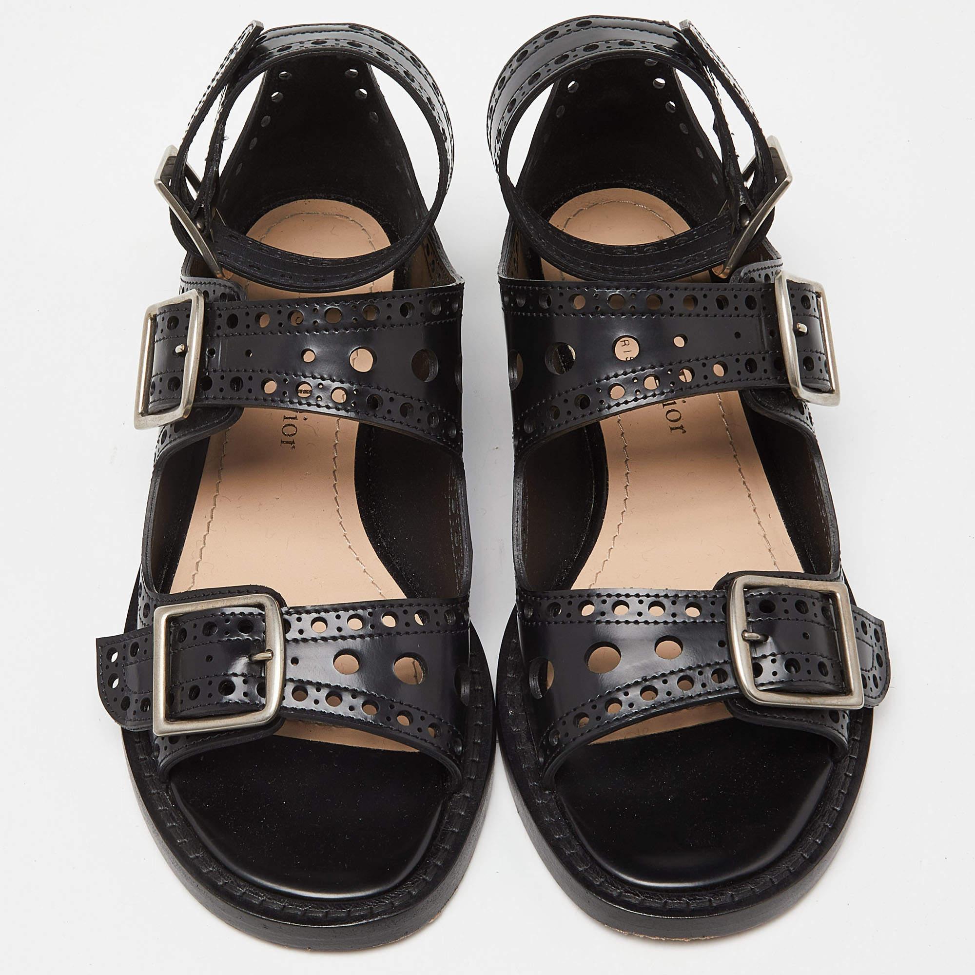 Frame your feet with these Dior flat sandals. Sewn using leather, the flats have three buckles, perforated lines, and open toes. They'll be perfect with short, midi as well as maxi hemlines.


