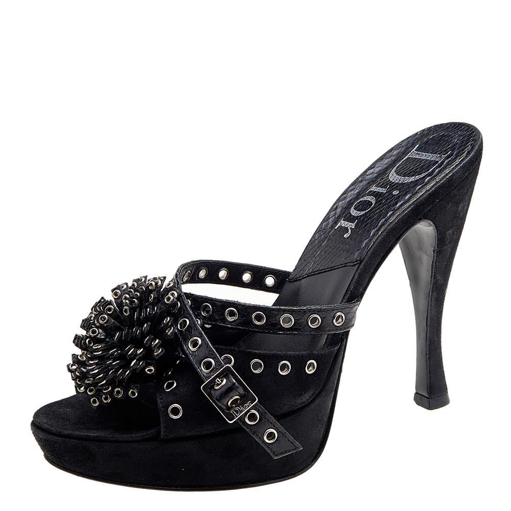 Exude poise and perfection as you walk in these slide sandals from the House of Dior. They are crafted using black perforated suede and python skin on the exterior. They flaunt eyelet embellishments and 12 cm heels. Make a stunning style statement