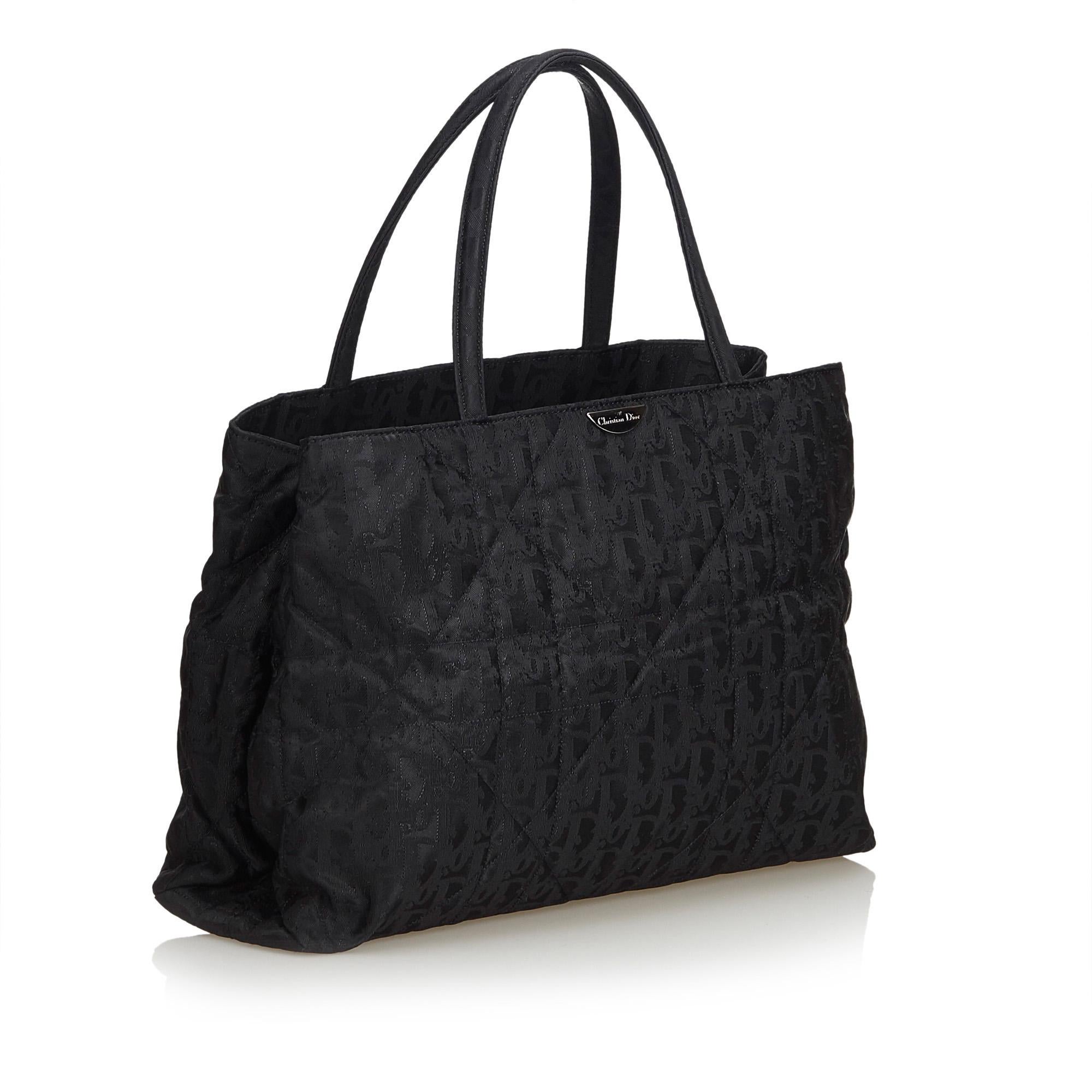 This tote bag features a nylon body, flat straps, open top, and interior zip and open pocket. It carries as AB condition rating.

Inclusions: 
Dust Bag

Dimensions:
Length: 22.00 cm
Width: 33.00 cm
Depth: 10.00 cm
Hand Drop: 15.00 cm
Shoulder Drop: