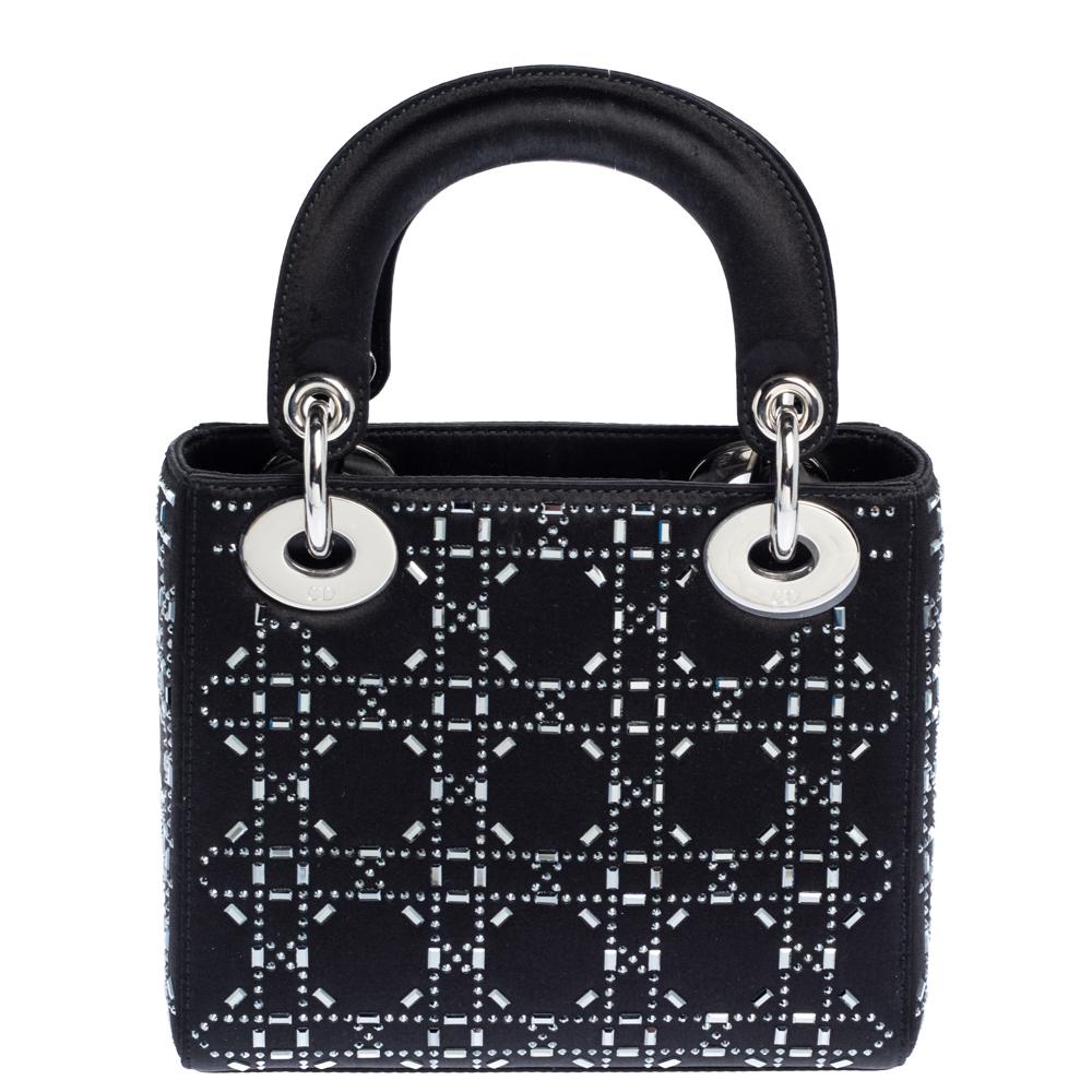 The Lady Dior tote is a Dior creation that has gained recognition worldwide and is today a coveted bag that every fashionista craves to possess. This black tote has been crafted from luxe satin and it carries the signature Cannage quilt detail with