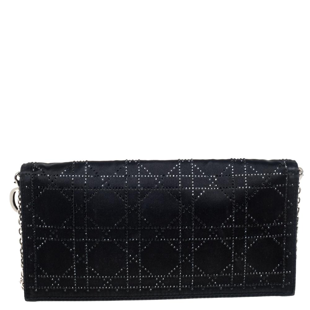 This gorgeous clutch from Dior is a perfect piece to carry to that evening party. It has been crafted from the finest quality satin and has a rich black color. The exterior is embellished with crystals that form the signature Cannage pattern and the
