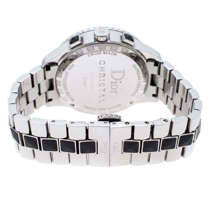 This Dior watch is from their Christal collection and has a stylish stainless steel case of diameter 38 mm and is held by a stainless steel bracelet accented with black gemstones all over its length. It has a well-designed bezel enclosed within