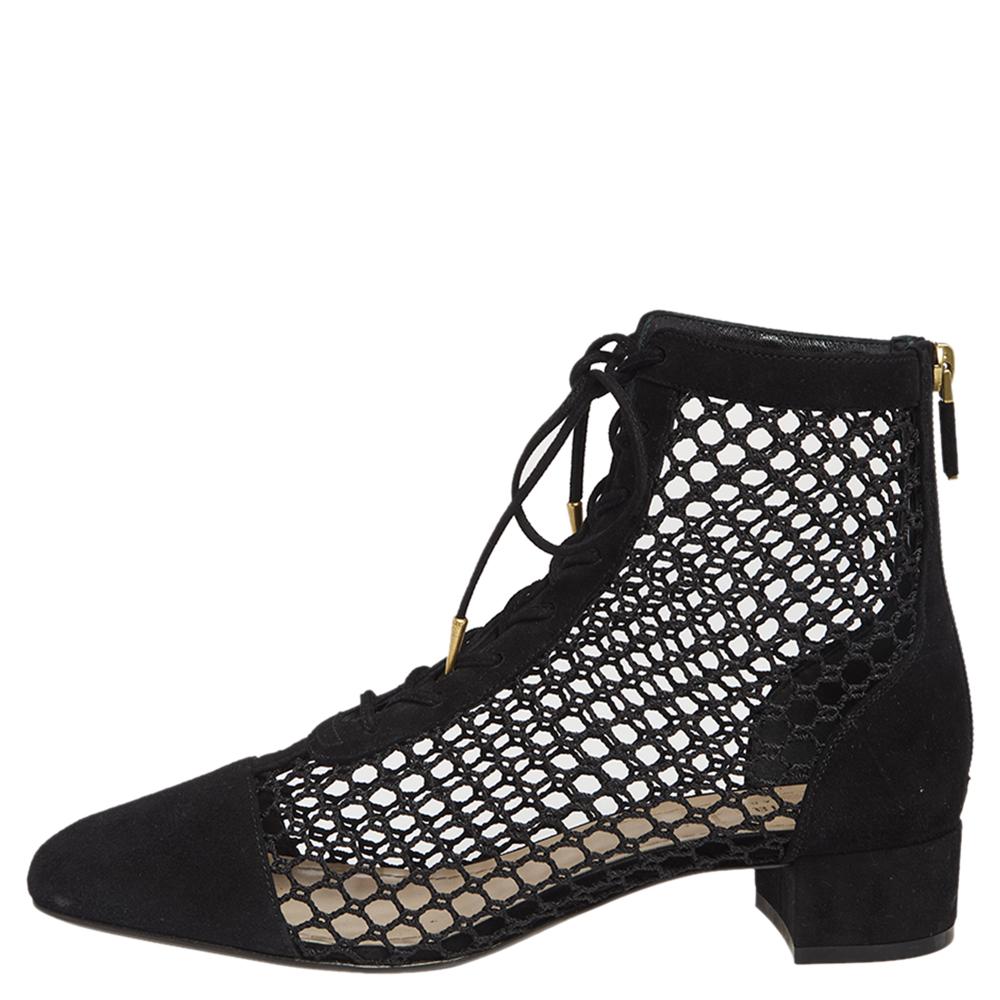 These ankle boots by Dior are for those who are not afraid to make a statement! Crafted meticulously from quality suede & mesh, they come in a classic shade of black. They are styled with covered toes, fishnet style body with tie-up detailing, low