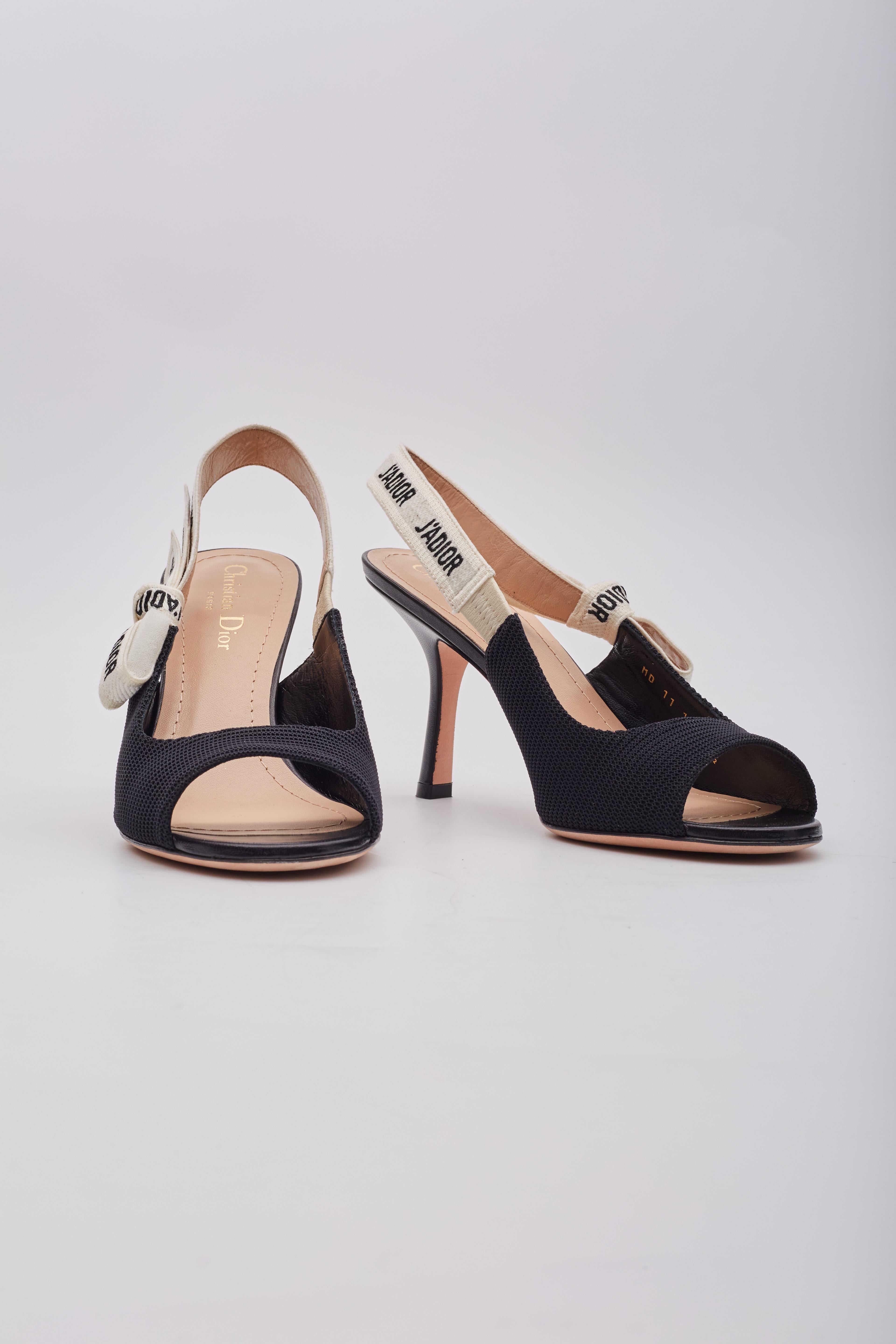 The J'Adior slingback pumps are crafted in the Italian ateliers of black technical fabric. The heels features a two-tone 'J'Adior' cotton ribbon with a bow embellishment, a 90mm heel height, a leather sole with a star motif and the brands lucky