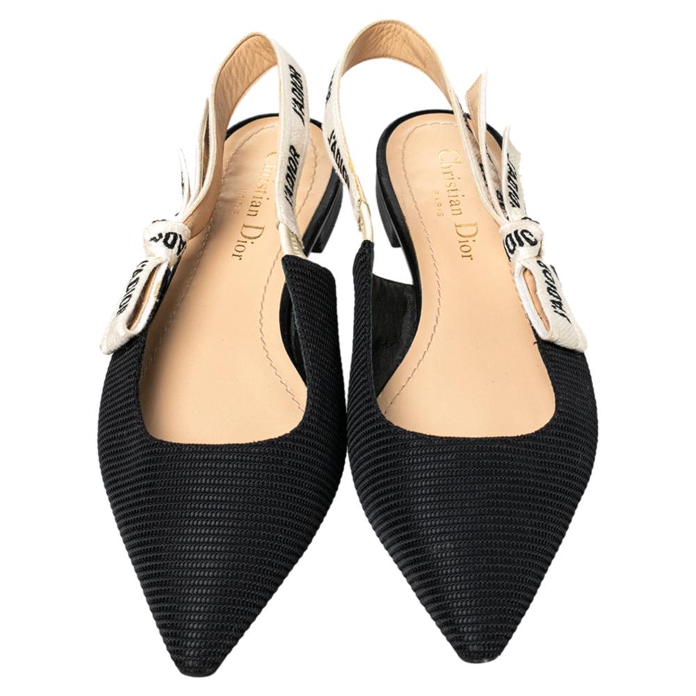 Endless compliments will come your way every time you wear these Dior flats. The black flats are crafted from technical fabric and styled with pointed toes and 'J'adior' ribbon slingbacks. They are complete with comfortable leather insoles and